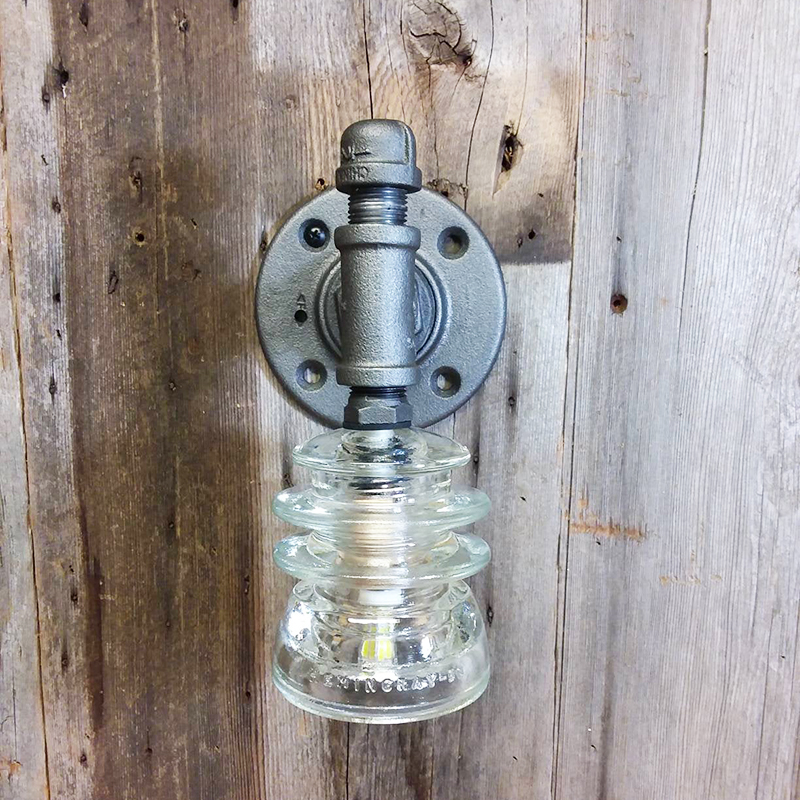 Looking for modern farmhouse light fixtures? Well, these five beauties are the real deal as they were all handmade! Like this glass insulator wall sconce by IndustrialReworks.