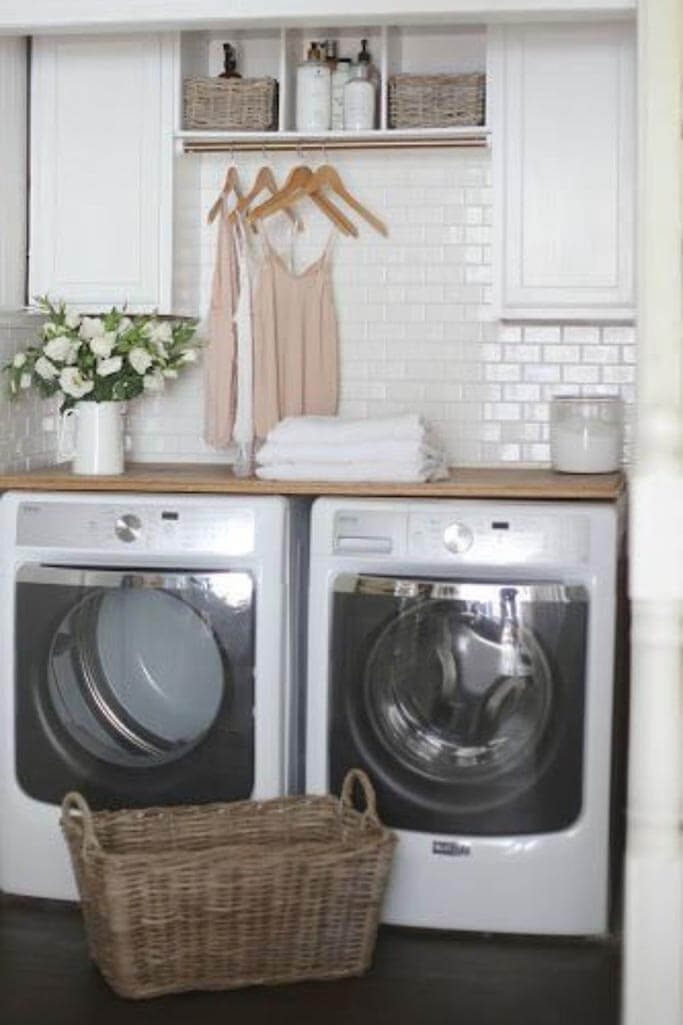 A pretty laundry room with a white washer and dryer.