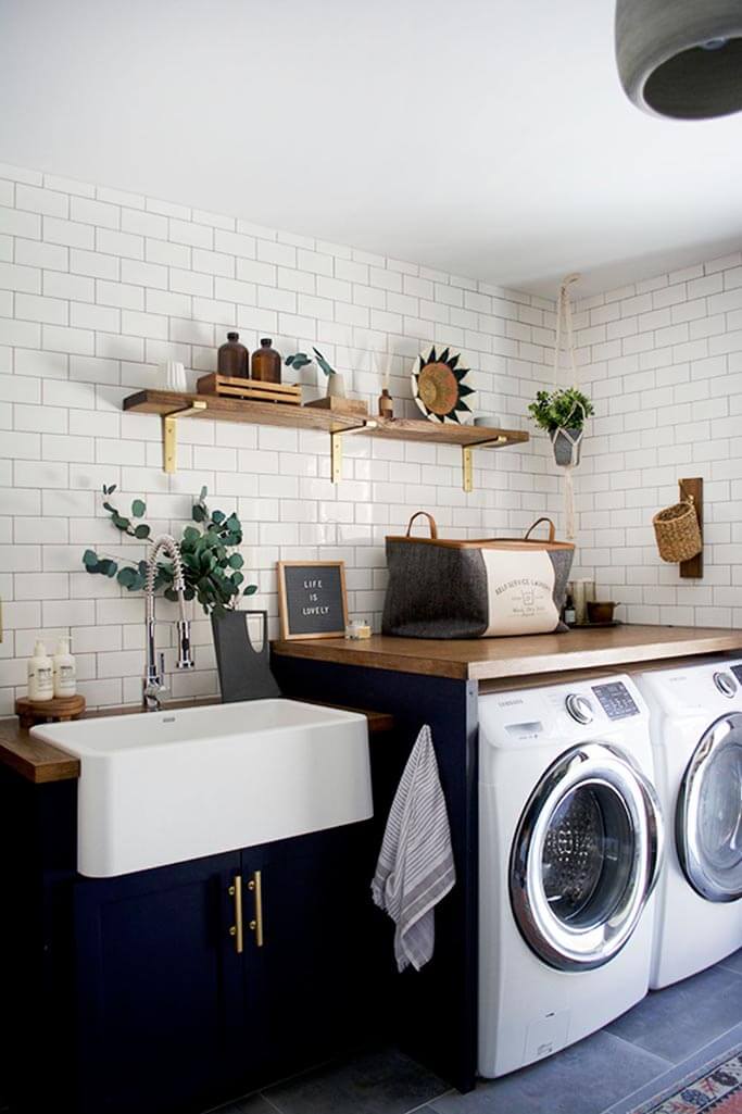 A laundry room black cabinets and a white washer and dryer.