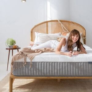 A woman relaxing on a white and grey mattress.