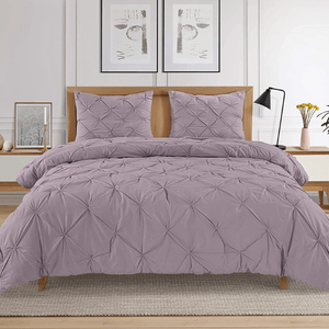 A bedroom with purple bedding.