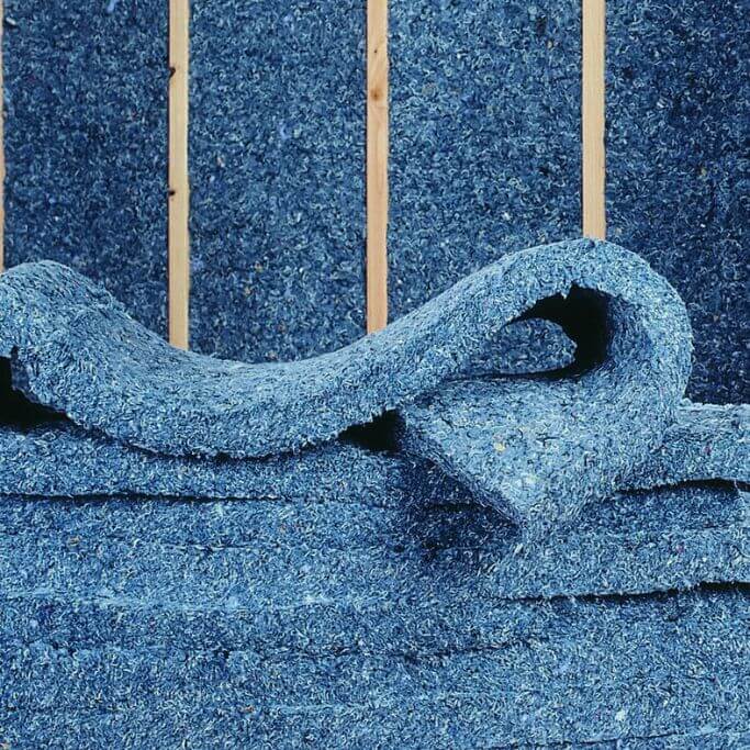 Blue insulation made from recycled denim in a wood stud wall.