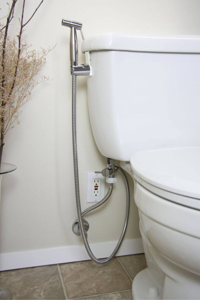 A toilet with a bidet attachment.