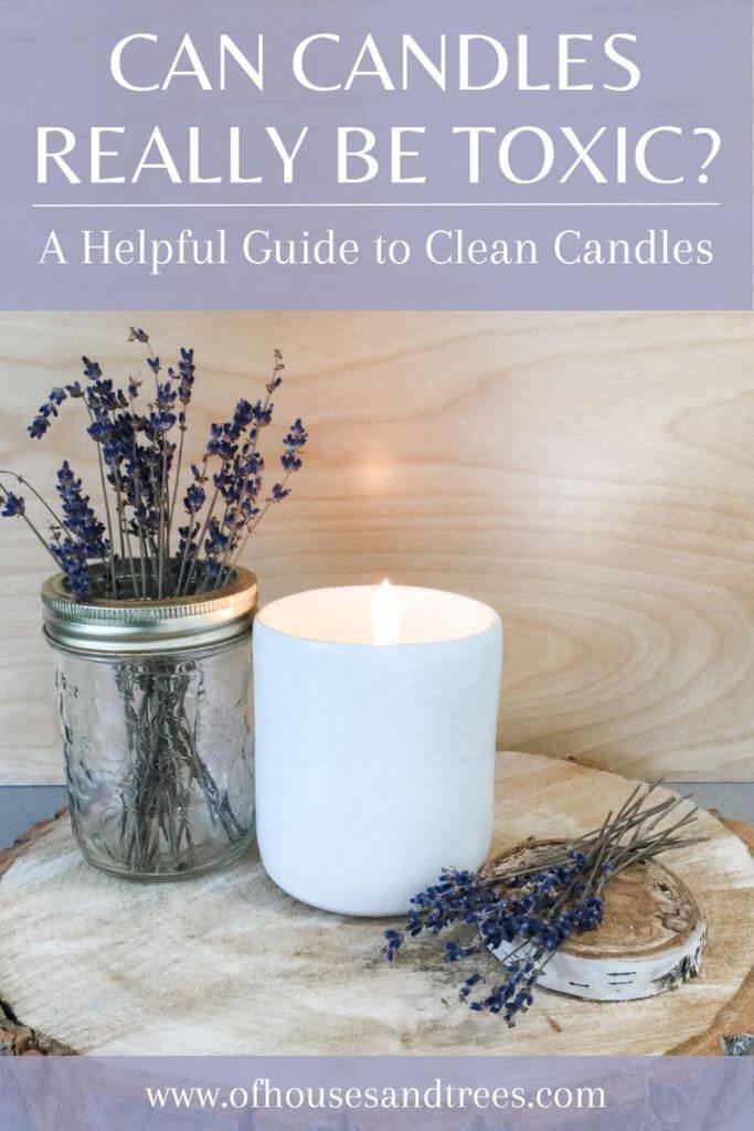 A candle in a white vessel sitting on top of a wood slice next to dried lavender with text can candles really be toxic.