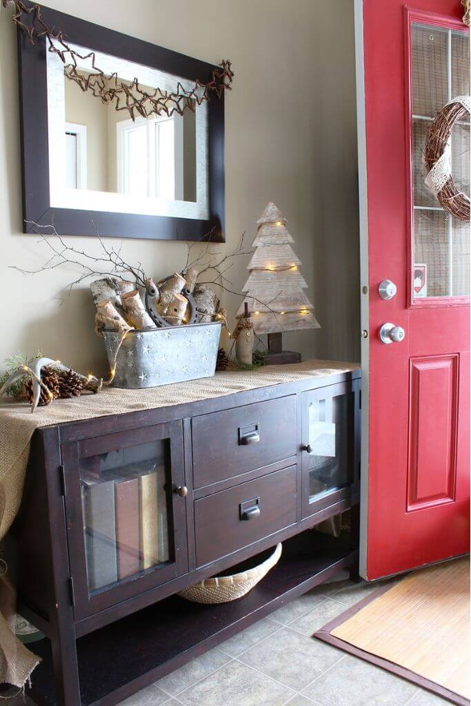 A front entryway of a home decorated for a rustic christmas.