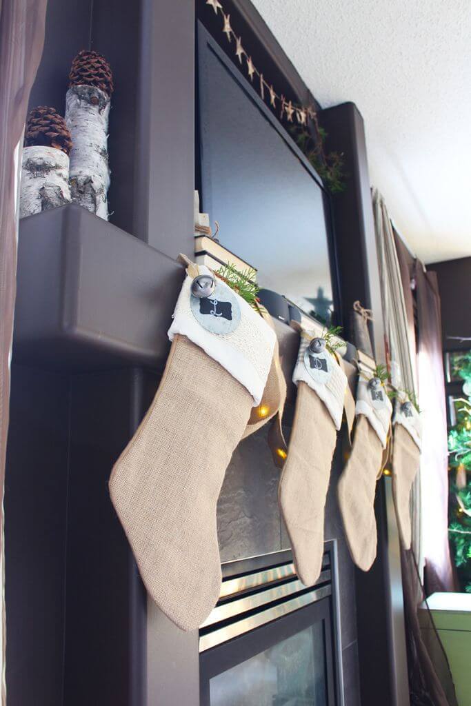 A row of burlap stockings hanging on a fireplace mantel.