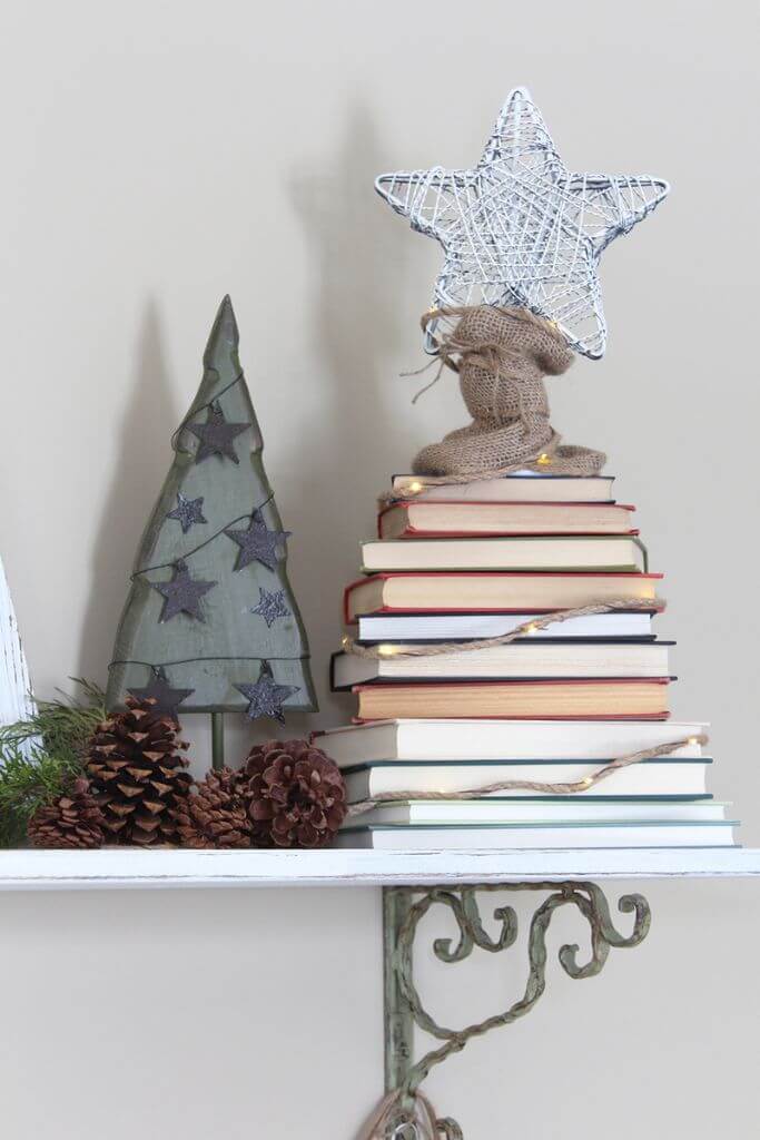 A stack of books decorated to look like a Christmas tree.