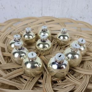 small silver round Christmas ornaments in a wicker basket.