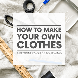 Sewing supplies such as pins, needles, scissors, thread and a ruler laying on a piece of grey fabric with the words "how to make your own clothes - a beginner's guide to sewing." Click to visit post.