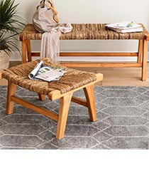 Two wooden benches on a grey rug.