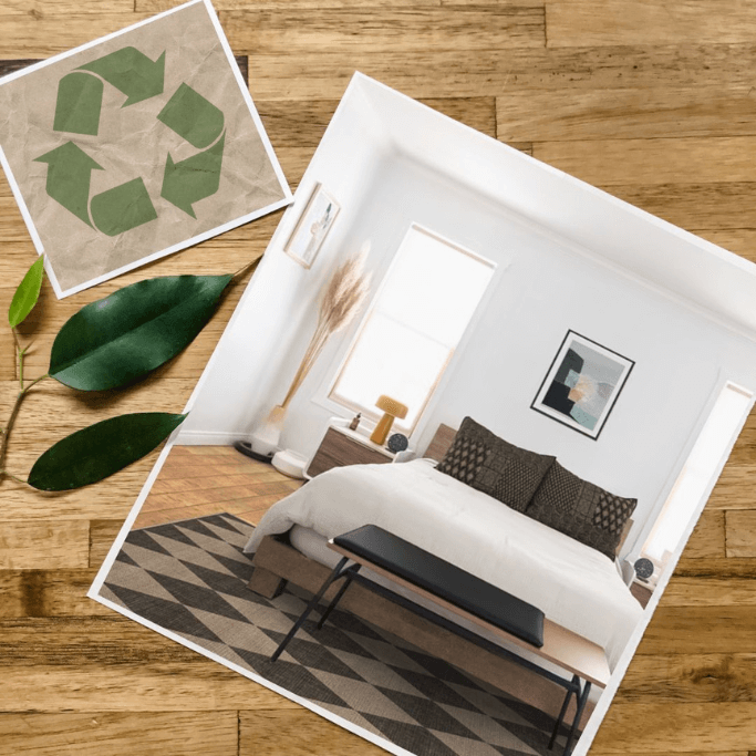 A photo of a neutral bedroom and a photo of the recycling symbol sitting on a wooden table next to three green leaves.