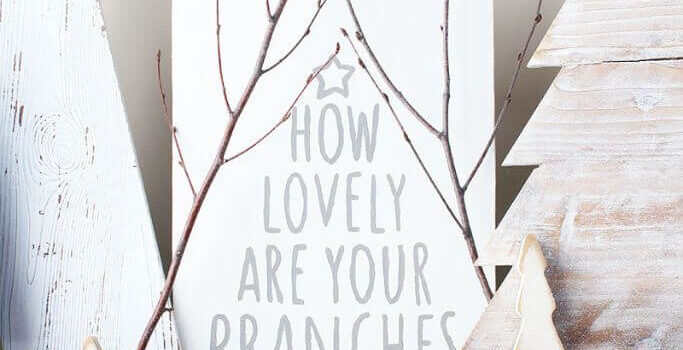 Rustic Christmas decor including a sign with text how lovely are your branches.
