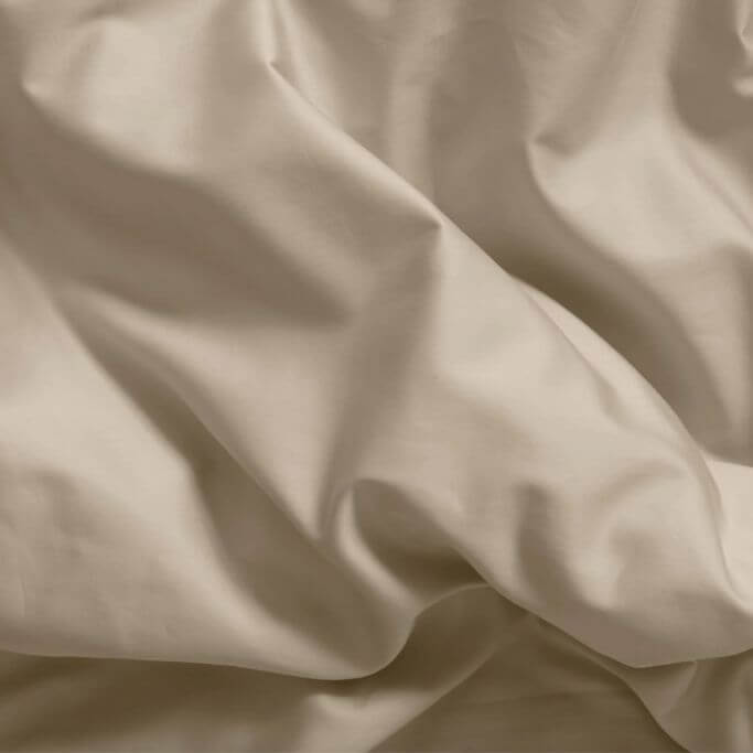 Closeup of a beige-coloured bedsheet.