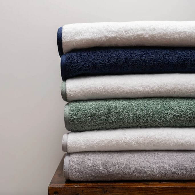 A pile of folded towels in different colours.