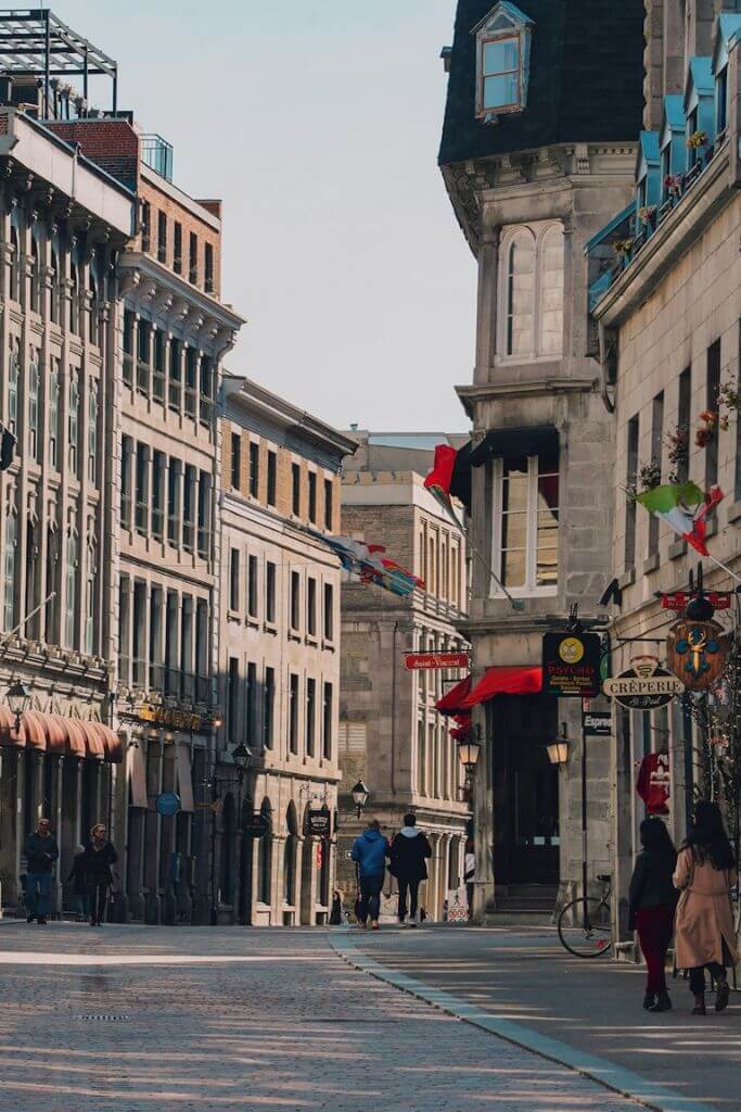 Older section of Montreal with tall buildings and a narrow street.