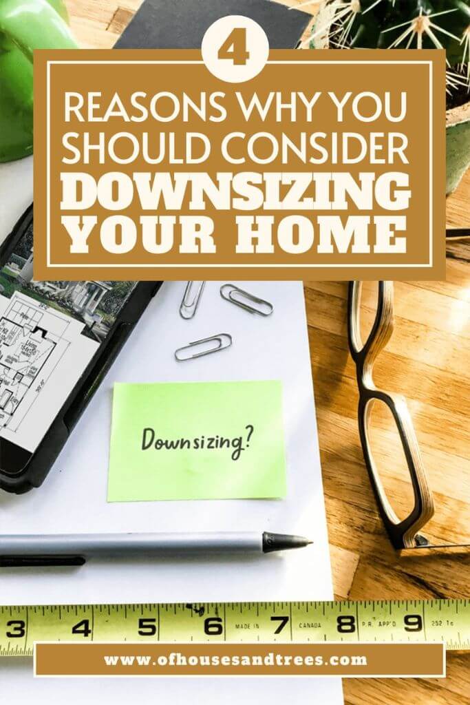 Office supplies such as paperclips and a pen sitting on a wood table with a phone, a pair of glasses and a tape measurer and text 4 reasons why you should consider downsizing your home.