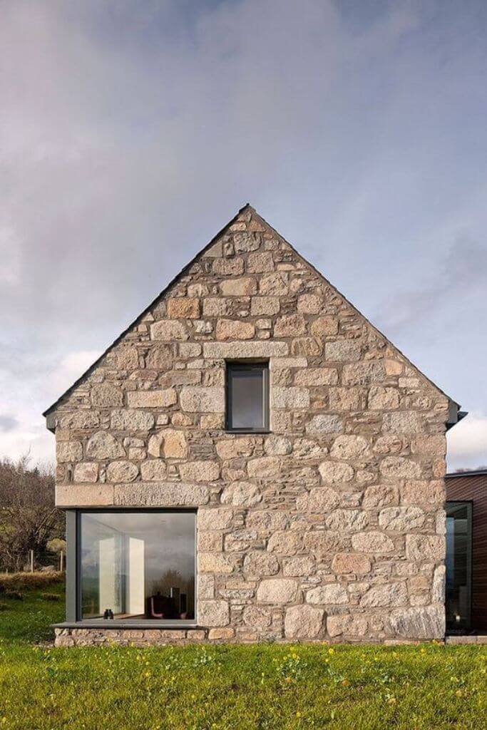 A home exterior made from stone with an aged looked.