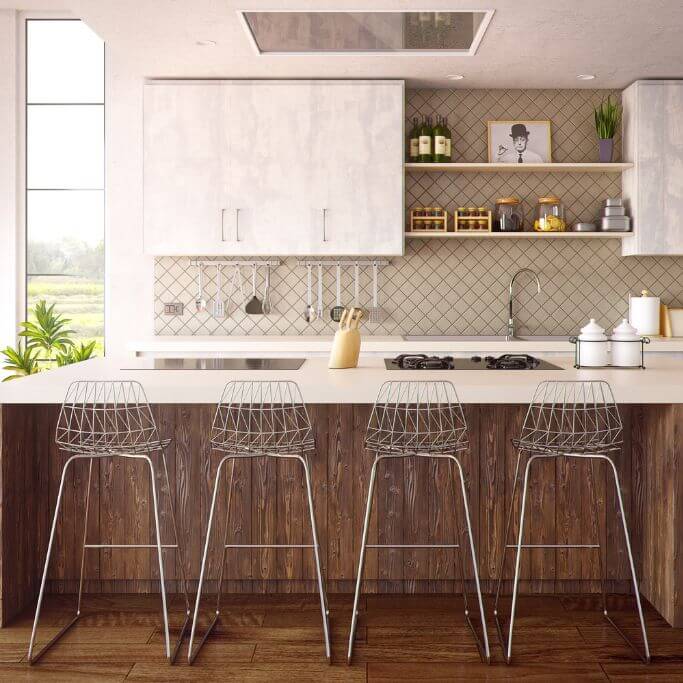 White and wood kitchen with silver barstools and vintage accessories.