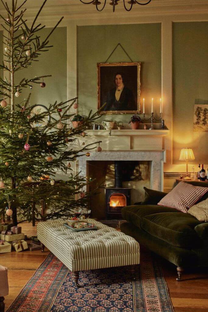 A green traditional style living room decorated for Christmas.