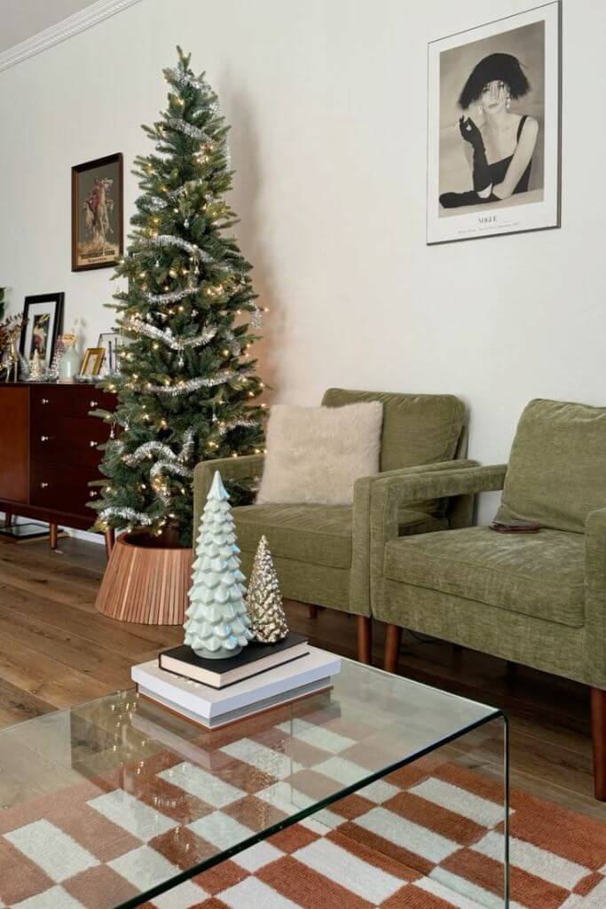 A living room with two green armchairs decorated for Christmas.