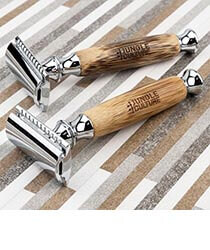 Two wood and metal razors on a striped background. Click to visit Jungle Culture website.