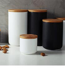 Black and white containers with wood lids.