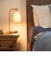A brass lamp on a nightstand.