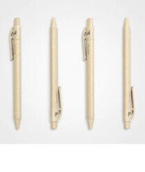 Four beige-coloured pens on a grey background.
